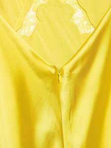 Detailansicht eines gelben Satin-Midikleids mit Spitzennähten und unsichtbarem Reißverschluss