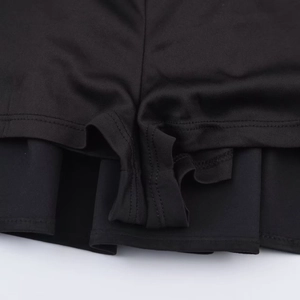 Close-up of black sports skort featuring flatlock stitching and anti-exposure inner shorts