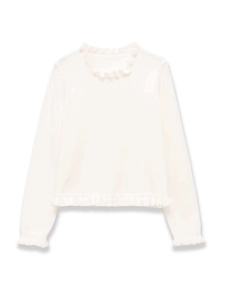 Detailed view of the layered ruffle edges on a white long-sleeve knit sweater