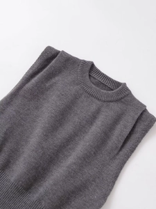 Detailed view of dark grey sleeveless knit top with ribbed crewneck and pleated shoulders