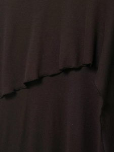 Detail of dark brown tiered ruffle hem with delicate overlock stitching on knit fabric