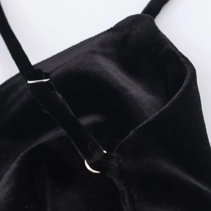 Detail of adjustable silver buckle and soft black velvet straps on an evening dress