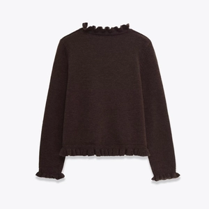 Detail of ruffle trim collar and knit texture on dark brown long sleeve sweater