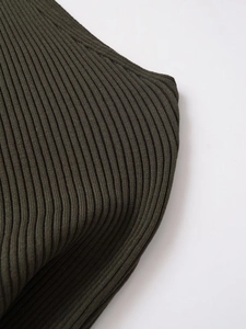 Macro detail of dark olive green ribbed knit fabric showing vertical textured weave patterns
