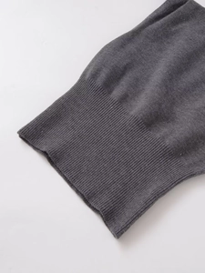 Detailed macro view of the dark grey ribbed knit cuff and fine fabric texture on the top