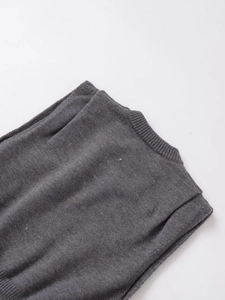 Detail of dark grey knit sleeveless top featuring ribbed neckline and soft texture