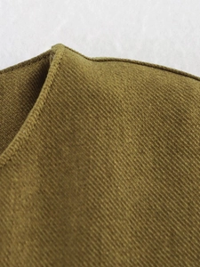 Close-up of fine ribbed corduroy texture and premium stitching on bomber jacket