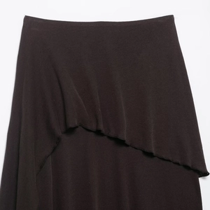 Dark brown knitted skirt featuring an irregular layered wave hem with asymmetric draping
