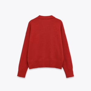 Detailed back view of red long-sleeve knit sweater with ribbed cuffs and hem