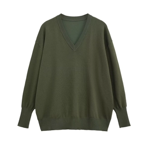 Women's V-neck loose knit sweater in dark green with ribbed cuffs on white background