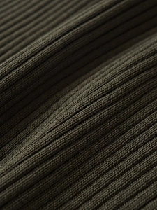 Detailed close-up of ribbed olive green knit fabric showing premium texture and fibers