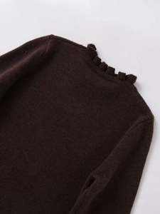 Close-up of a dark brown knit sweater featuring elegant ruffled collar and fine texture