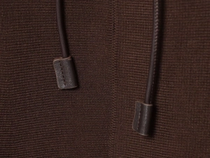 Macro detail of dark brown knit texture and premium drawstring with leather ends