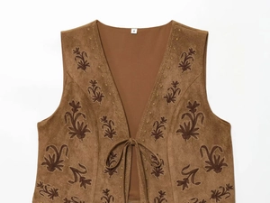 Close-up of brown suede vest featuring floral embroidery with S size label detail