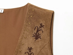 Detailed embroidery on brown faux suede vest with golden floral patterns and V-neckline