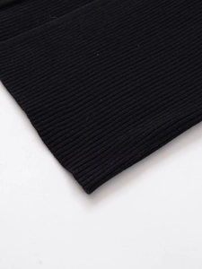 Macro shot of black ribbed knit fabric showing detailed texture and elastic vertical lines