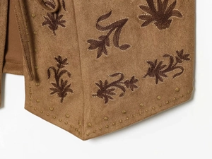 Detail view of brown suede vest with vintage floral embroidery and golden stitch accents