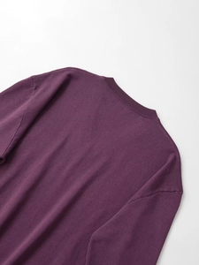 Detail view of the ribbed V-neck collar and high-quality purple knit fabric texture