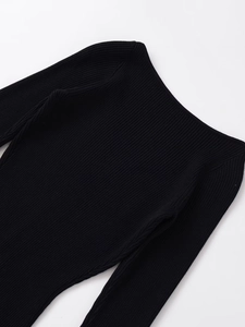 Detailed view of the fine ribbed texture on a black slim fit knit midi dress