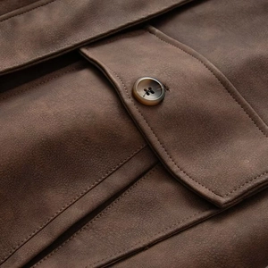 Detailed macro of suede texture jacket with reinforced stitching and resin button