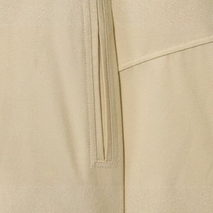 Minimalist beige twill jacket with sleek faux leather collar and detailed pocket stitching