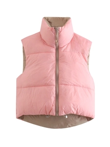 Detail of pink puffer vest showing high stand collar and brown contrast lining detail