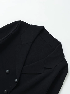 Close-up of black knitted blazer collar with fine texture and stylish button detail