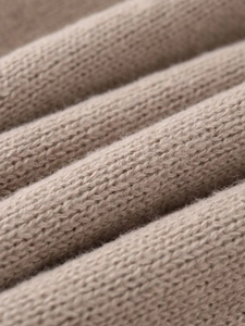 Close-up of the beige ribbed knit texture showing soft wool blend fabric detail