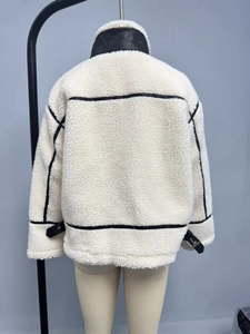 Back view of a cream faux shearling jacket with black leather trim and metal buckles