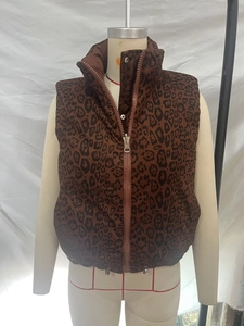 Detailed view of leopard print puffer vest with standing collar and zipper closure