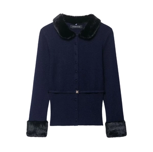 Detail of navy knit cardigan featuring black faux fur collar and gold metal waist buckle
