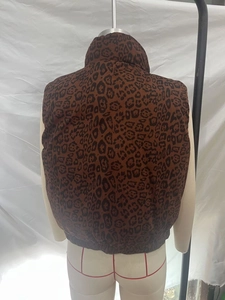 Detail of the leopard print vest showing stand collar and elastic hem on a mannequin