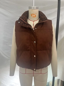 Close-up of brown suede-textured vest featuring a leopard print collar and silver buttons