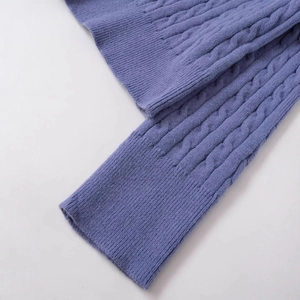 Classic cable-knit sweater in soft blue featuring ribbed cuffs and detailed texture