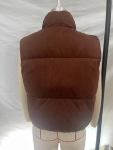 Back view of a brown quilted puffer vest featuring a high stand collar and matte finish