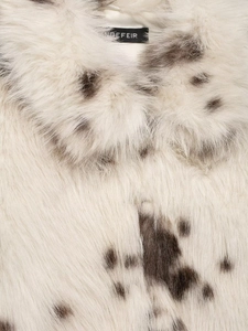 Detail of the soft faux fur fabric with animal print and brand label on the neckline