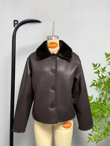 Detail of dark brown faux leather jacket with plush shearling collar and button closure