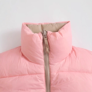 Pink quilted vest with stand collar, khaki lining, and zipper detail for winter warmth