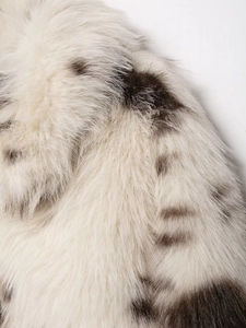 Macro detail of soft faux fur material featuring realistic brown animal spots and texture