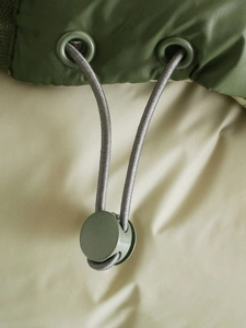 Detail of adjustable drawstring with army green toggle and high-density woven cord