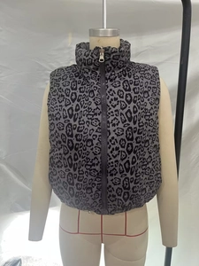 Detailed front view of a grey leopard print down vest with high collar and metal zipper