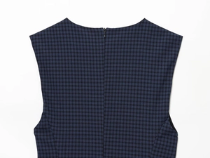Detail of navy plaid mini dress featuring a back invisible zipper and round neckline