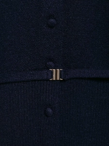 Detail of navy knit sweater featuring decorative matching buttons and gold metal hardware