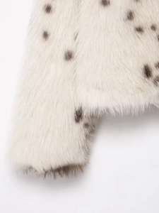 Macro shot of faux fur texture with animal print and soft white plush material details
