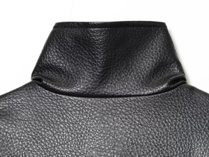 Détail de la texture en similicuir noir et des coutures du col sur la veste