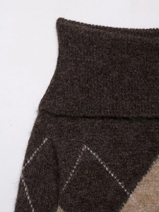 Close-up of diamond pattern knitwear with fluffy wool texture and argyle stitching detail