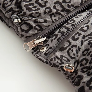 Detail of leopard print vest featuring metal zipper and adjustable drawstring hem
