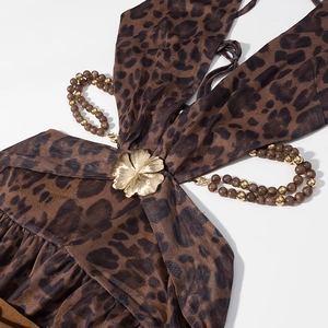 Détail de la robe léopard avec fleur en métal doré et fines bretelles en perles