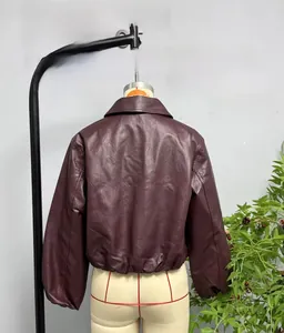 Macro detail of wine red faux leather jacket showing back hem and elasticated cuff finish