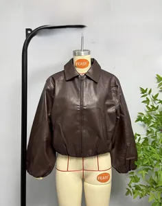 Close-up of deep brown leather jacket with classic collar and ribbed elastic cuffs